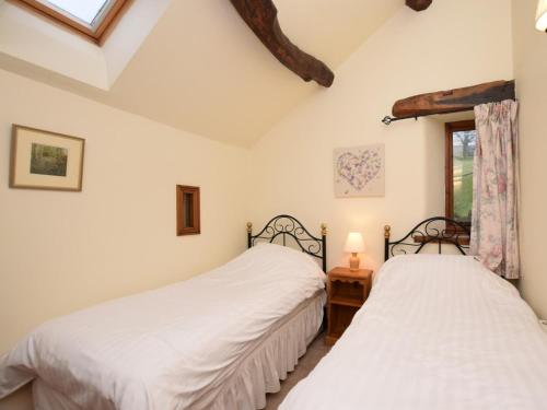 two beds in a room with a window at 3 Bed in Hope Valley oc-pk432 in Aston