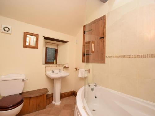 a bathroom with a toilet and a sink and a tub at 3 Bed in Hope Valley oc-pk432 in Aston