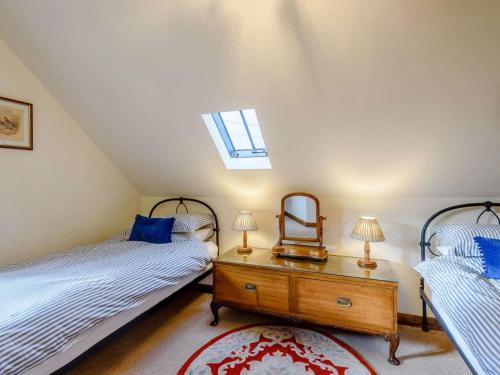 a attic bedroom with two beds and a mirror at 2 Bed in Shrewsbury oc-86590 in Leighton