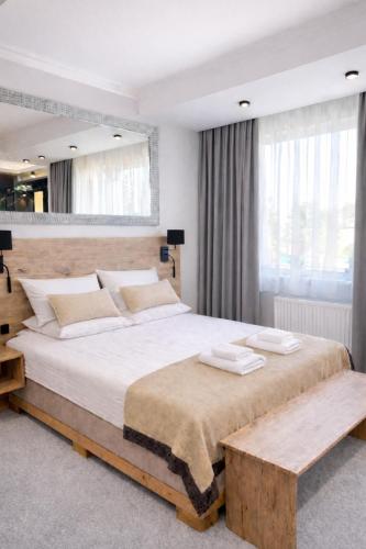 a bedroom with a large bed and a large window at Hotel Ajax in Janki