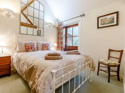 a bedroom with a white bed and a chair at 1 Bed in Leighton oc-80726 in Leighton