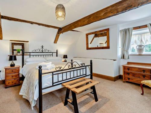 a bedroom with a bed and a wooden table at 8 Bed in Bristol oc-87469 in Winterbourne