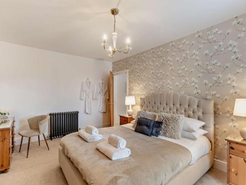 a bedroom with a large bed with towels on it at 2 Bed in Morpeth oc-91206 in Amble
