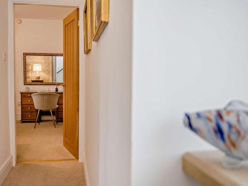 a hallway with a room with a mirror and a chair at 2 Bed in Morpeth oc-91206 in Amble