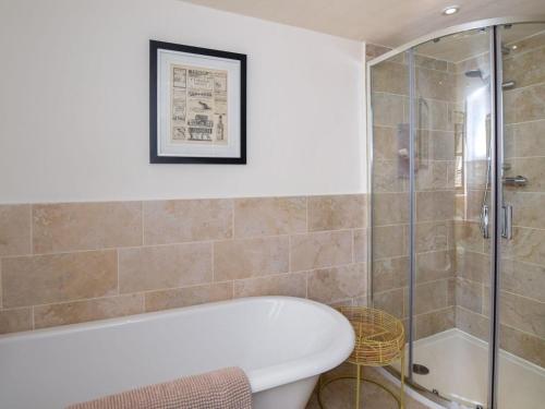 a bathroom with a tub and a glass shower at 2 Bed in Ludlow oc-40329 in Ludlow