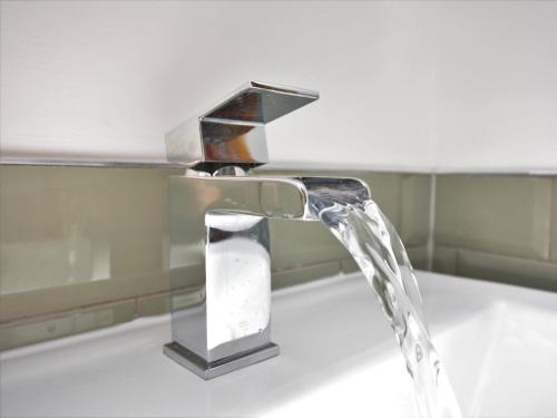 a water faucet on a sink in a bathroom at 1 Bed in Buxton oc-58958 in Flash