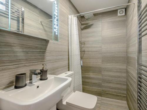 a bathroom with a sink and a toilet and a shower at 1 Bed in Buxton oc-74351 in Flash