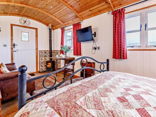 a bedroom with a bed and a couch and a television at 1 Bed in Shrewsbury oc-80587 in Leighton