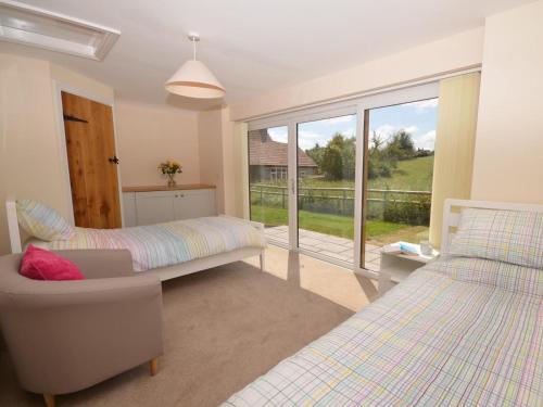a bedroom with two beds and a chair and a window at 2 Bed in Bristol oc-75697 in Bristol
