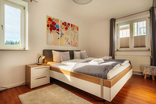 a bedroom with a bed with a painting on the wall at Klippenblick in Schierke