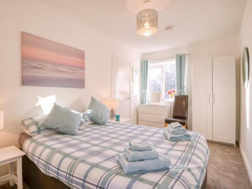 a bedroom with a bed with blue towels on it at 1 Bed in Filey oc-77709 in Hunmanby