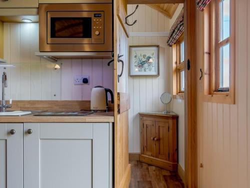 a kitchen with white cabinets and a microwave at 1 Bed in Shrewsbury oc-77906 in Leighton
