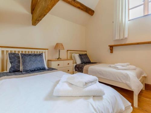 a bedroom with two beds with towels on them at 2 Bed in Ludlow oc-59293 in Lane to Richards Castle