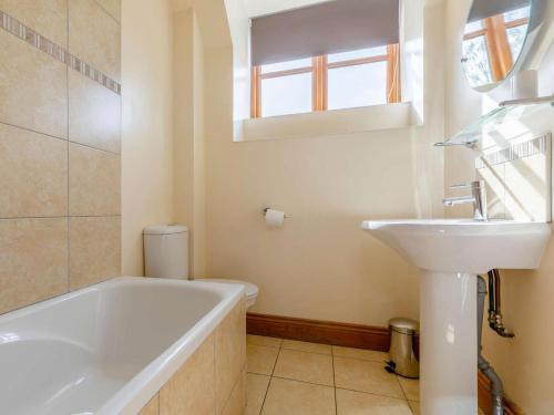 a bathroom with a white tub and a sink at 2 Bed in Ludlow oc-59293 in Lane to Richards Castle