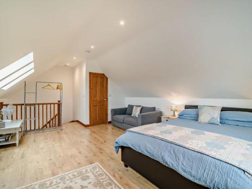 a bedroom with a bed and a couch and a chair at 1 Bed in Bristol oc-72835 in Chew Magna