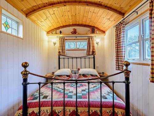 a bedroom with a bed with a wooden ceiling at 1 Bed in Leighton oc-80727 in Leighton
