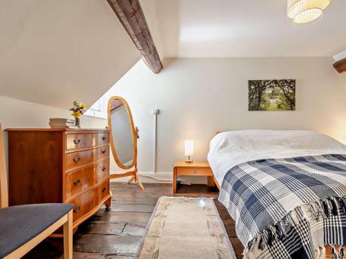 a bedroom with a bed and a dresser and a mirror at 1 Bed in Kidderminster oc-82957 in Cleobury Mortimer