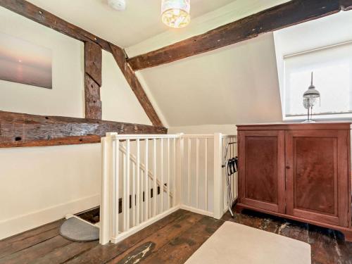 an attic room with a staircase and wooden beams at 1 Bed in Kidderminster oc-82957 in Cleobury Mortimer
