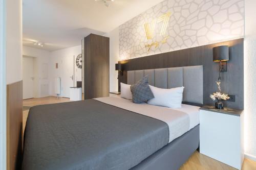 a bedroom with a large bed in a room at V7 Boutique Appartements in Freiburg im Breisgau