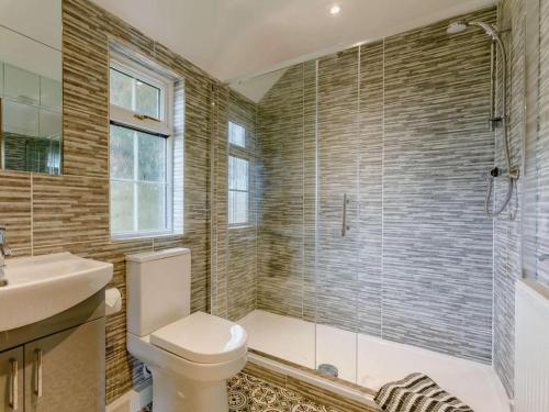 a bathroom with a shower and a toilet and a sink at 1 Bed in Cinderford oc-88272 in Cinderford