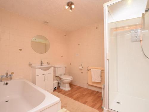 a bathroom with a tub and a toilet and a sink at 2 Bed in High Peak oc-pk551 in Hayfield