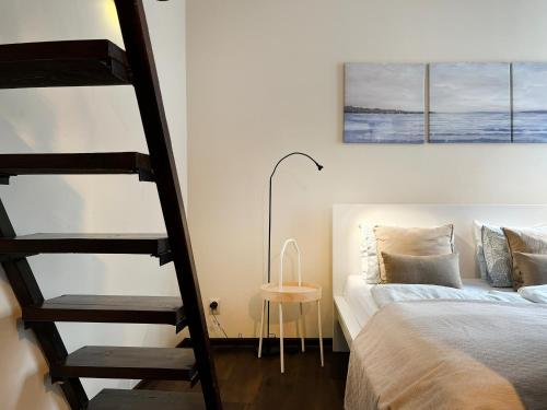 a bedroom with a bunk bed and a ladder next to a bed at Beautiful Studio for 4 guests, Main Square, Cracow in Krakow