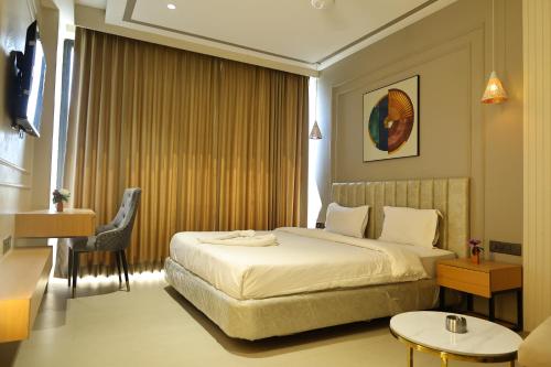 a hotel room with a bed and a chair at Manratan Resort in Narsinghgarh