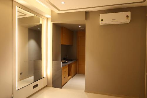 a small kitchen with a sink and a ceiling at Manratan Resort in Narsinghgarh