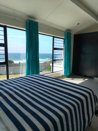 a bedroom with a bed and a view of the ocean at Shotleft on Wye RD in Margate