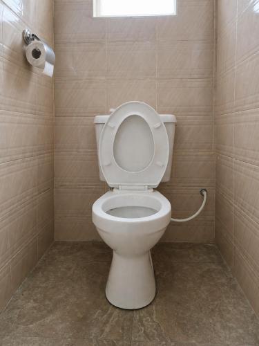 a bathroom with a toilet with the lid up at Pivot Studio near Westside mall in Nakuru