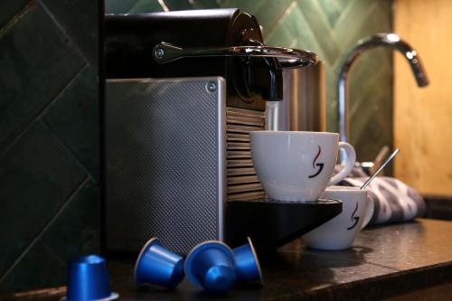 a kitchen counter with two cups and a coffee maker at Annika Apartments summer card included in Zell am See