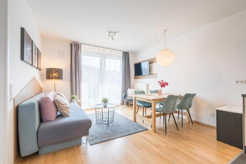 a living room with a couch and a table at V7 Boutique Appartements in Freiburg im Breisgau