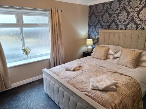 a bedroom with a large bed with a window at Old Coach House Apartment with Garage in Scarborough