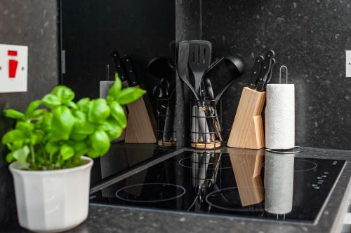 a counter with a bunch of kitchen utensils on it at Tambo Apartments in London