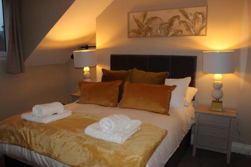 a bedroom with a bed with towels on it at Blackburn Heights Sleeps 4 Family Apartment in Bridlington