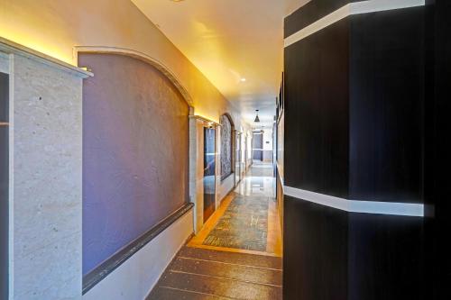 a hallway of a house with purple walls and wooden floors at FabHotel KV in Pen
