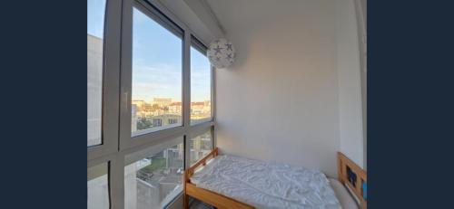 a room with a window with a bed in front of it at Exceptional, 12 minutes RER C from Paris in Juvisy-sur-Orge