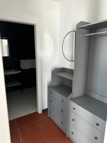a bedroom with a dresser and a mirror at Hotel Elu Iris in Split