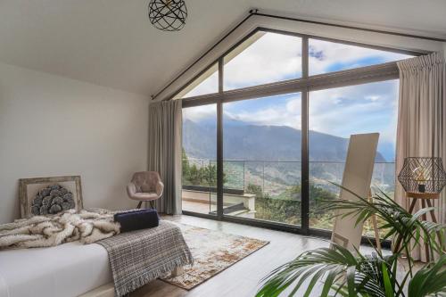 a bedroom with a large window with a view at Blue Horizon Luxury Villa in Senhora do Rosário