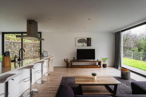 a living room with a table and a tv at Blue Horizon Luxury Villa in Senhora do Rosário