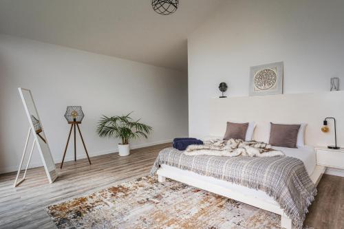 a white bedroom with a bed and a tripod at Blue Horizon Luxury Villa in Senhora do Rosário