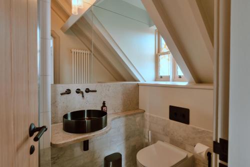 a bathroom with a sink and a toilet at Finest Retreats - ARC Next-The-Sea in Wells next the Sea