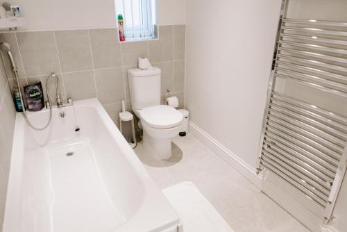 a bathroom with a toilet and a tub and a sink at 34 Buckthorn Grove, Middlesbrough, TS8 9BF in Middlesbrough