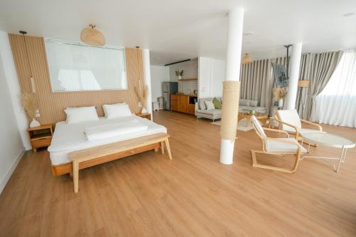 a bedroom with a bed and a living room at Beach Studio Level - WaveSide Ocean Bliss in Ko Phangan