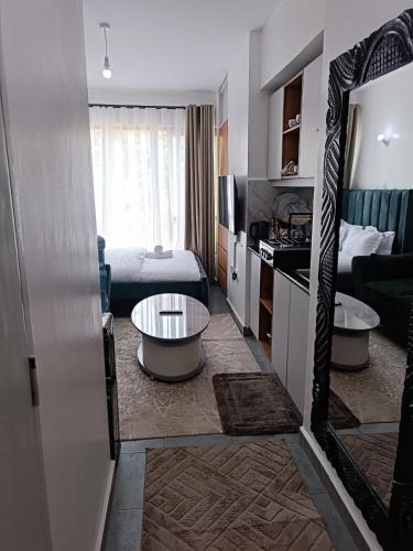a hotel room with a bed and a large mirror at Cozy Studio Kiambu Town in Kiambu