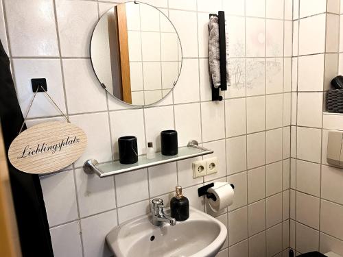 a bathroom with a sink and a mirror at Apartments Unterer Kochbuck in Crailsheim