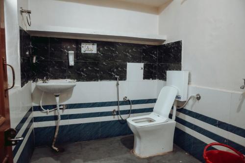 a bathroom with a toilet and a sink at Hotel The TWB palace in Gwalior