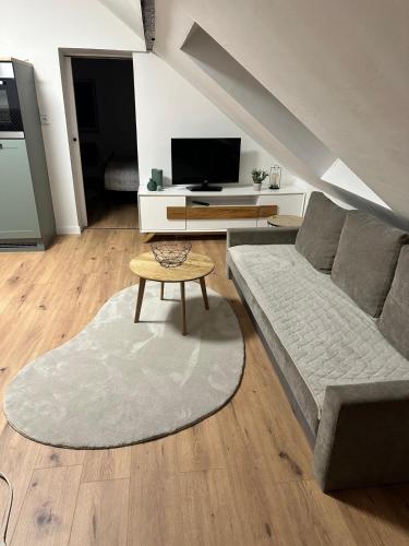 a living room with a couch and a table at Haus Lilium-Gemütliche Dachgeschoss Wohnung in Freudenstadt