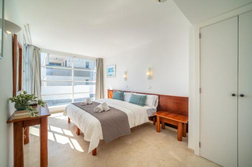 a bedroom with a large bed and a window at Villa Savina by BeBreeze in Can Picafort