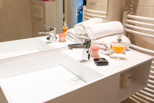 a bathroom with a sink and a mirror at Hotel Kyriad Lamballe in Lamballe